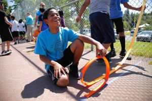 A student explores the physics of roller coasters at the Police Activities League.